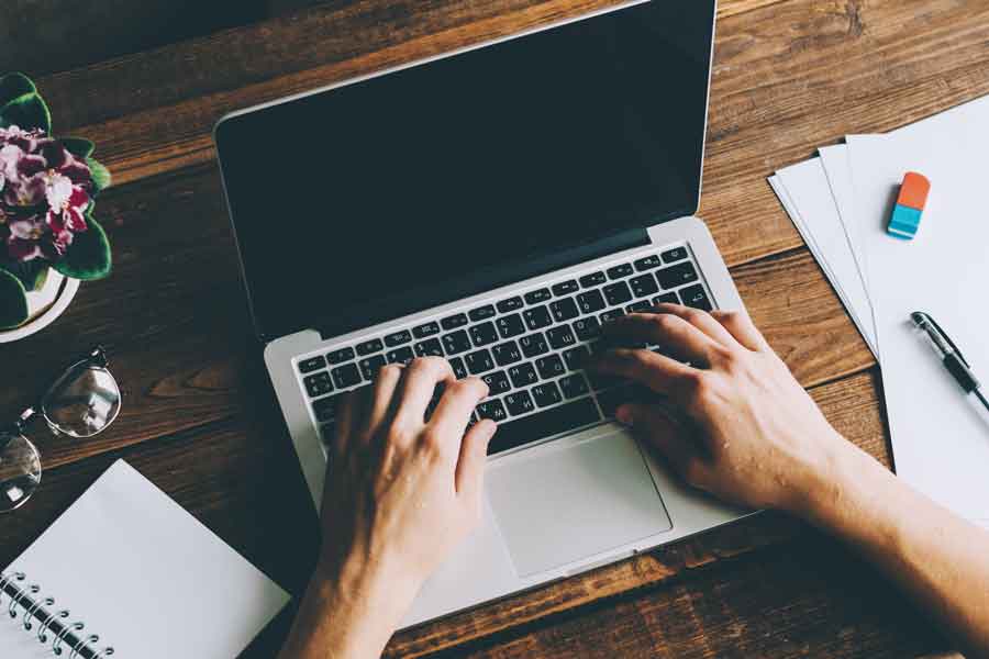 freelancer typing on his laptop computer