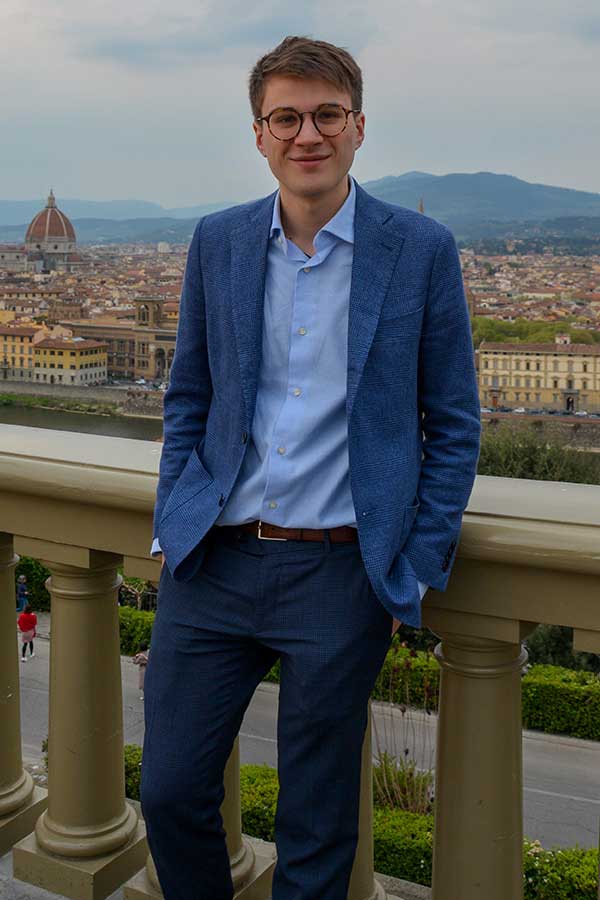 arrigo in a blue suit standing in piazza michelangelo of florence with a view